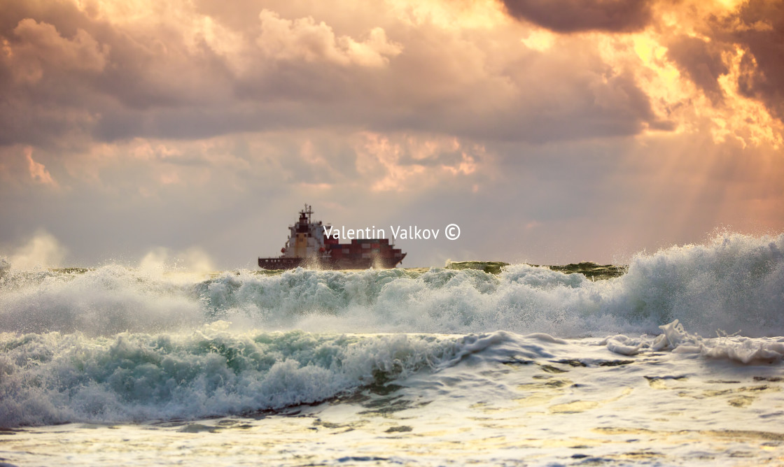 "Cargo ship with containers in sunrise light" stock image