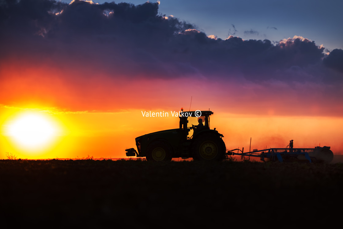 "Farmer in tractor preparing land with seedbed cultivator" stock image