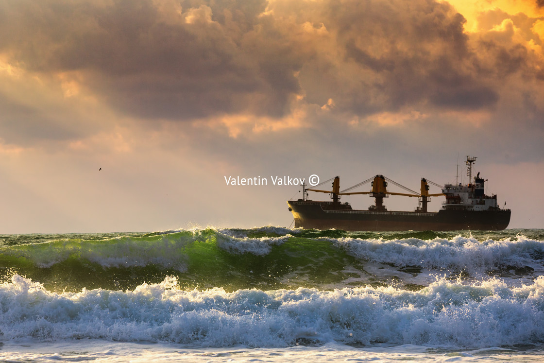 "Cargo ship with containers in sunrise light" stock image