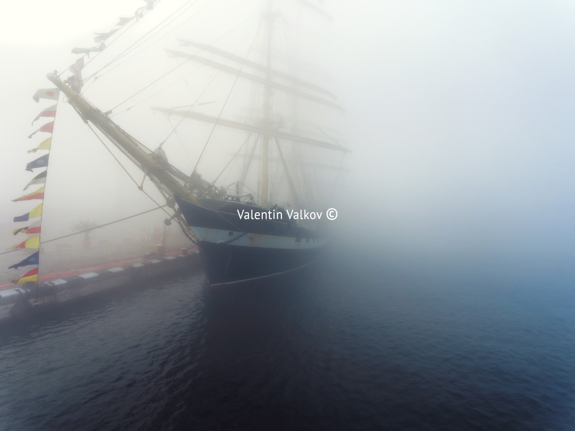 "Ship with flags in the fog early morning" stock image