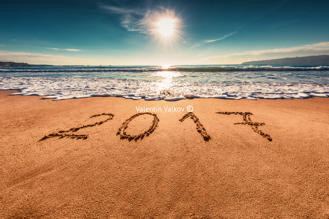 "Happy New Year 2017 concept, lettering on the beach" stock image