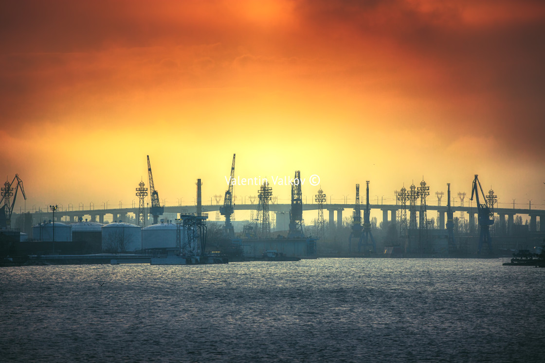 "Sunset and bridge with cranes" stock image