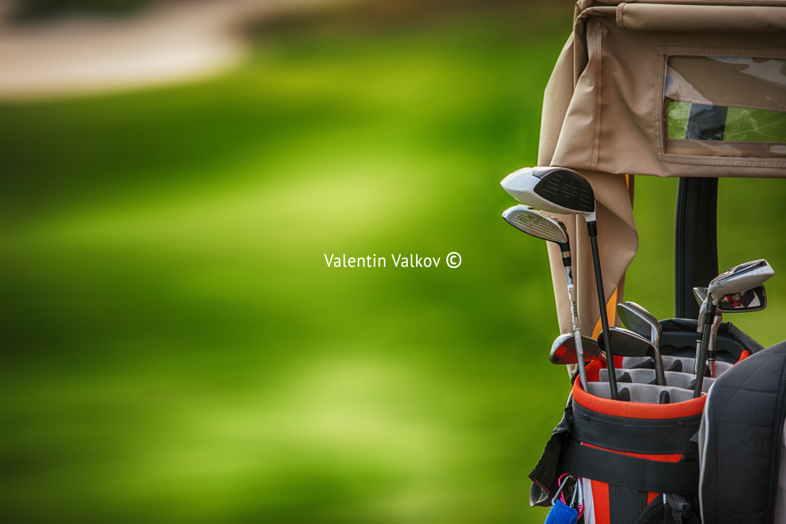 "Golf clubs drivers over green field" stock image