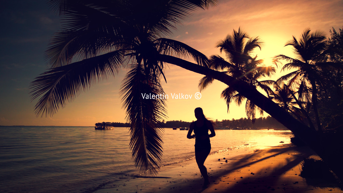 "Sea sunrise. Girl running on the tropical island beach Punta Can" stock image