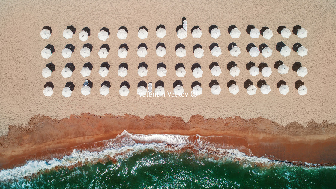 "Aerial top view on the beach. Umbrellas, sand and sea waves" stock image