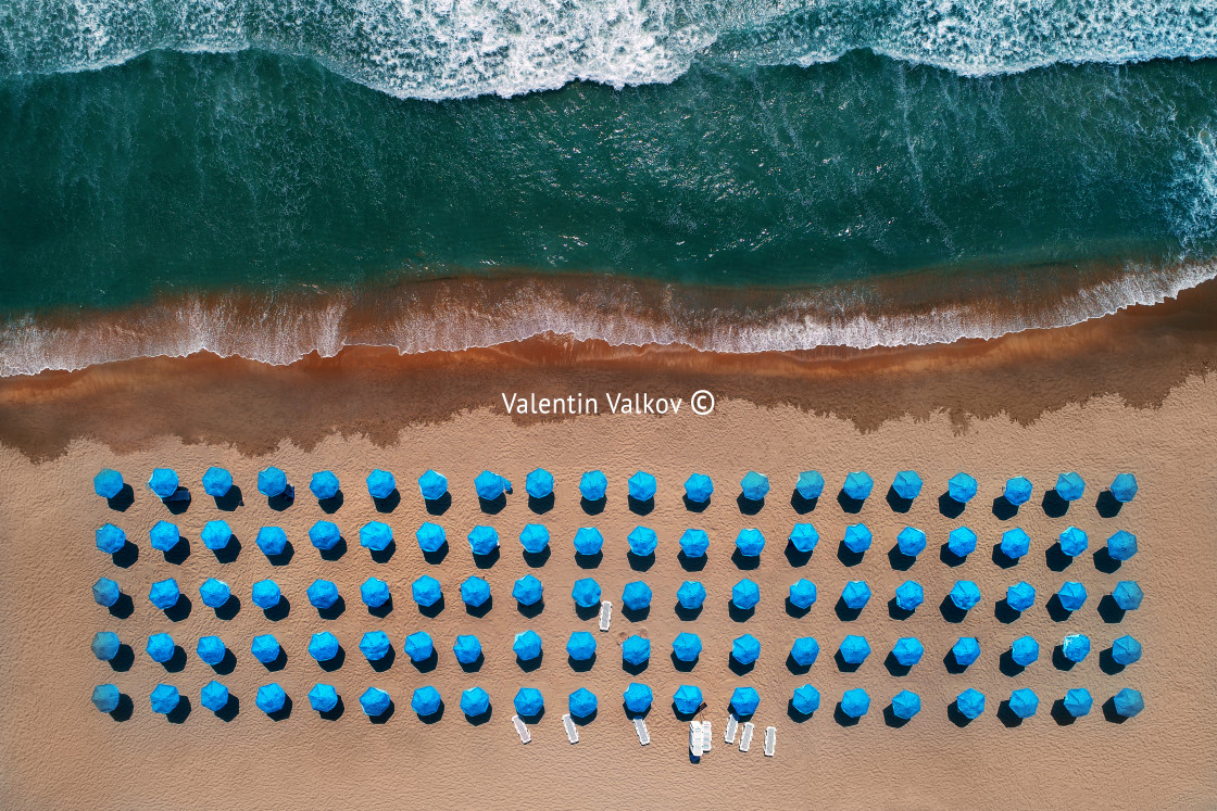 "Aerial top view on the beach. Umbrellas, sand and sea waves" stock image