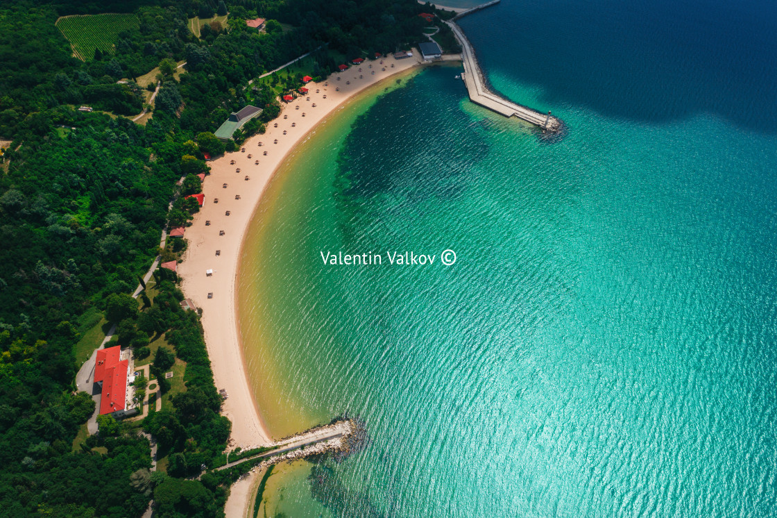 "Aerial drone view of a beautiful beach with white sand and umbre" stock image