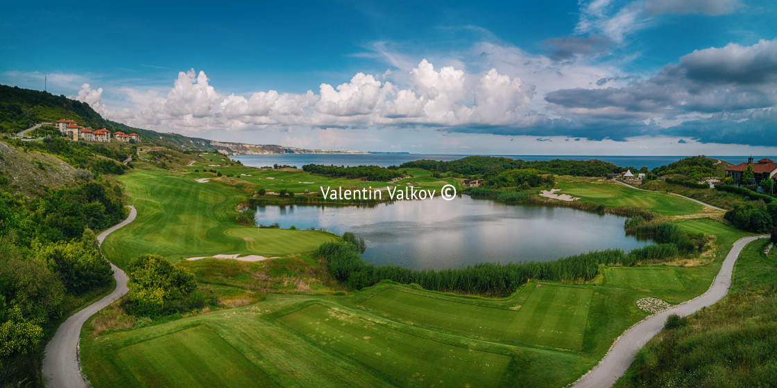 "Golf course in luxury resort with players. Aerial view of golfer" stock image