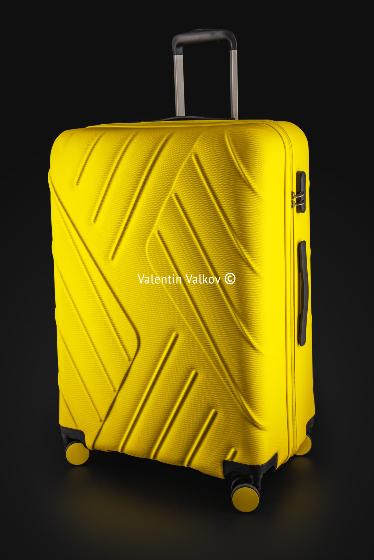 "Suitcase yellow with luggage for the flight isolated on black ba" stock image