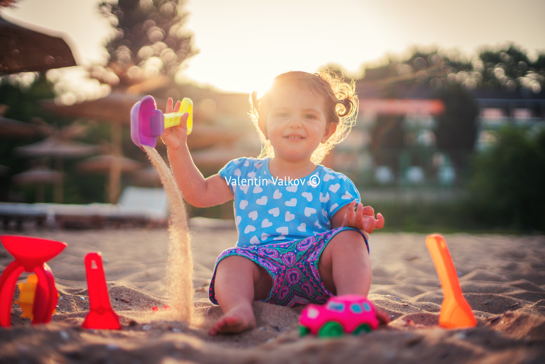 "Little girl playing on the beach" stock image