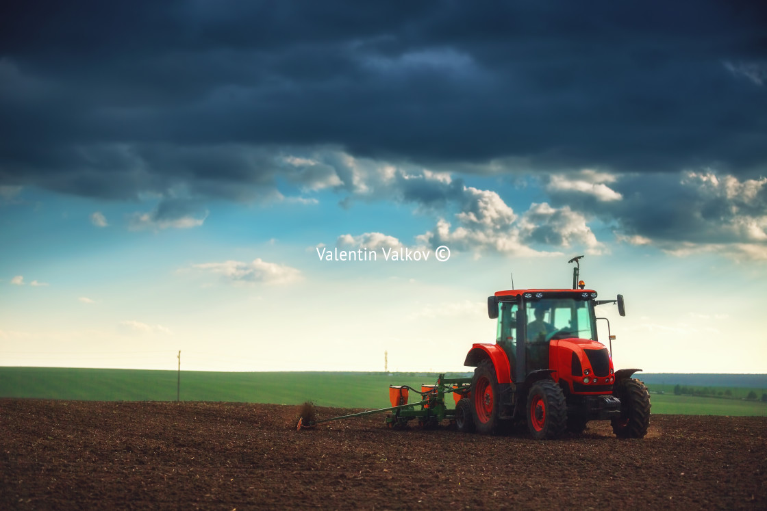 "Farmer in tractor preparing land with seedbed cultivator" stock image