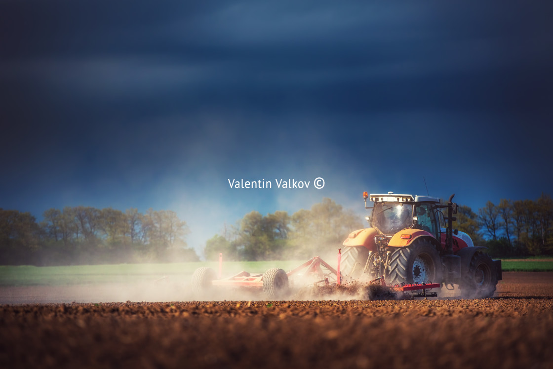 "Farmer in tractor preparing land with seedbed cultivator" stock image