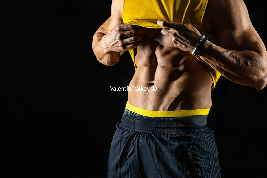 "Muscular and sexy torso of young athletic man isolated on black" stock image