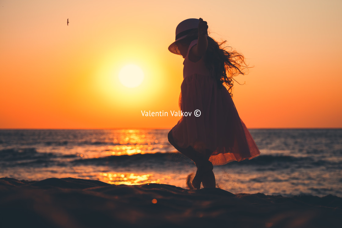 "Little girl playing on the beach" stock image