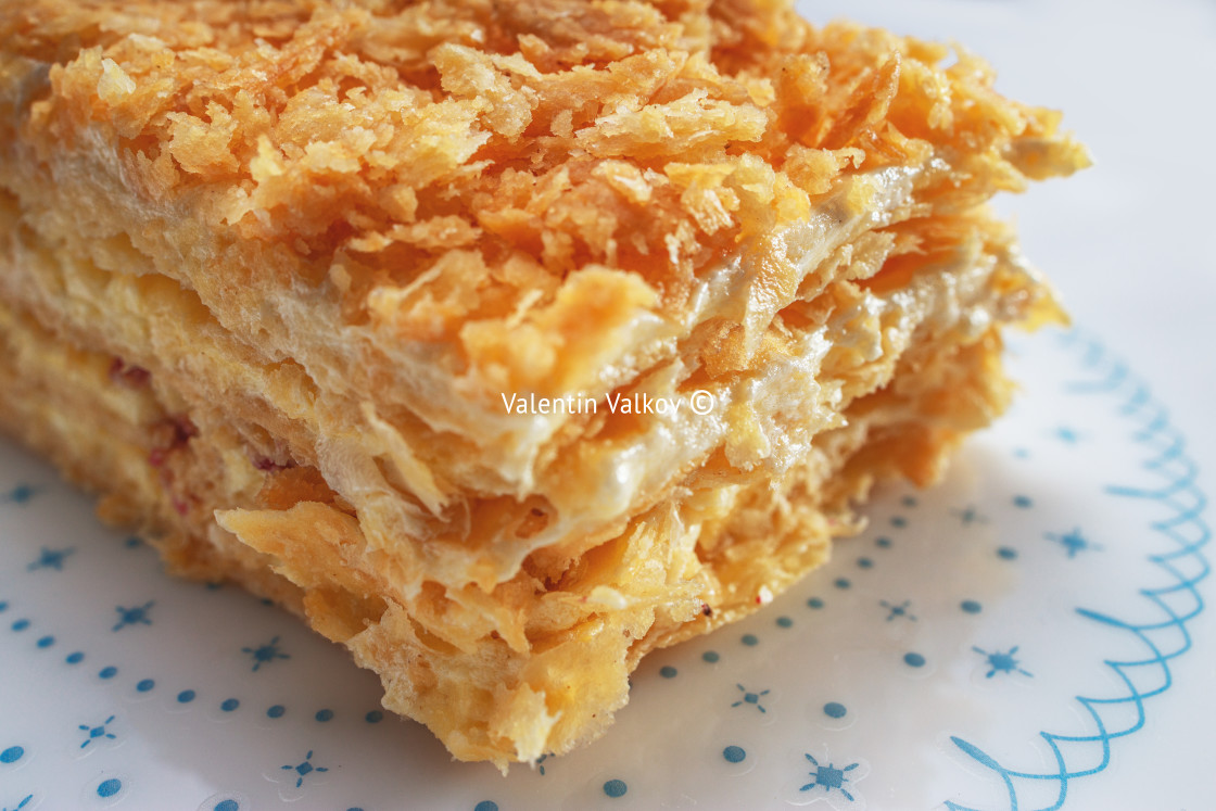 "Cake Napoleon with vanilla milk cream on a plate isolated on whi" stock image