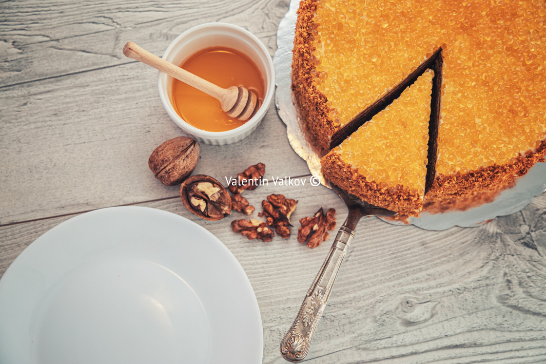 "Cake with honey, walnuts, cinnamon and golden pearls isolated ov" stock image