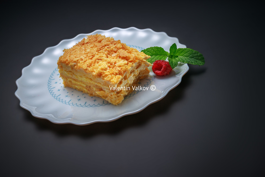 "Napoleon cake with vanilla milk cream and fruits on a plate isol" stock image