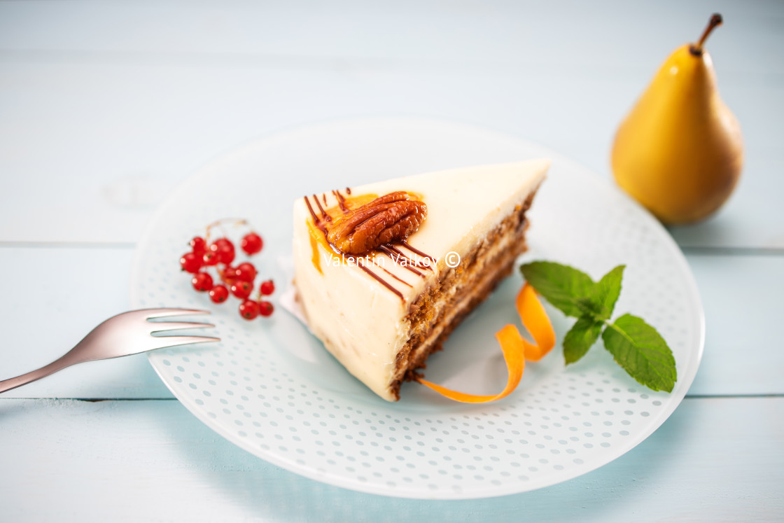 "Cake piece with chocolate, milk cream, carrots and nuts isolated" stock image