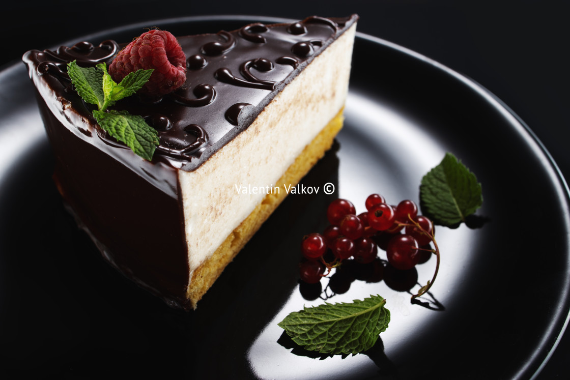 "Chocolate cake with decoration and fruits on black background" stock image