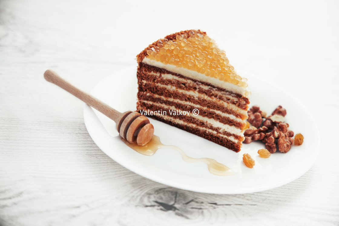 "Honey cake with golden pearls and mint leaf and cinnamon on ston" stock image