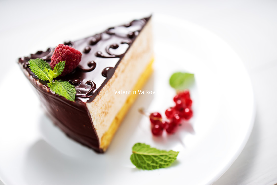 "Chocolate cake with decoration and fruits on white background" stock image