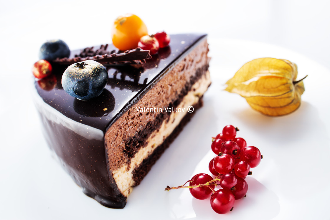 "Chocolate cake with decoration and fruits on white background" stock image