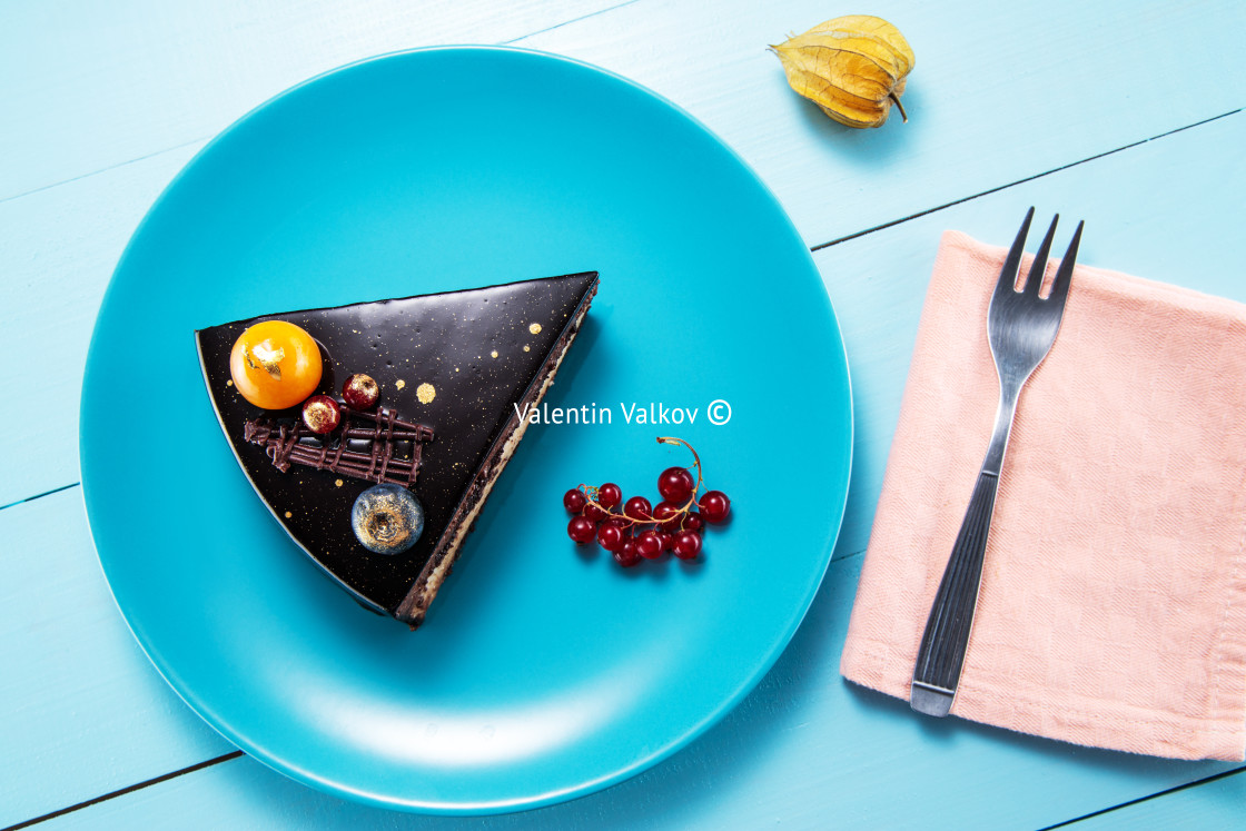 "Chocolate cake with decoration and fruits wooden blue background" stock image