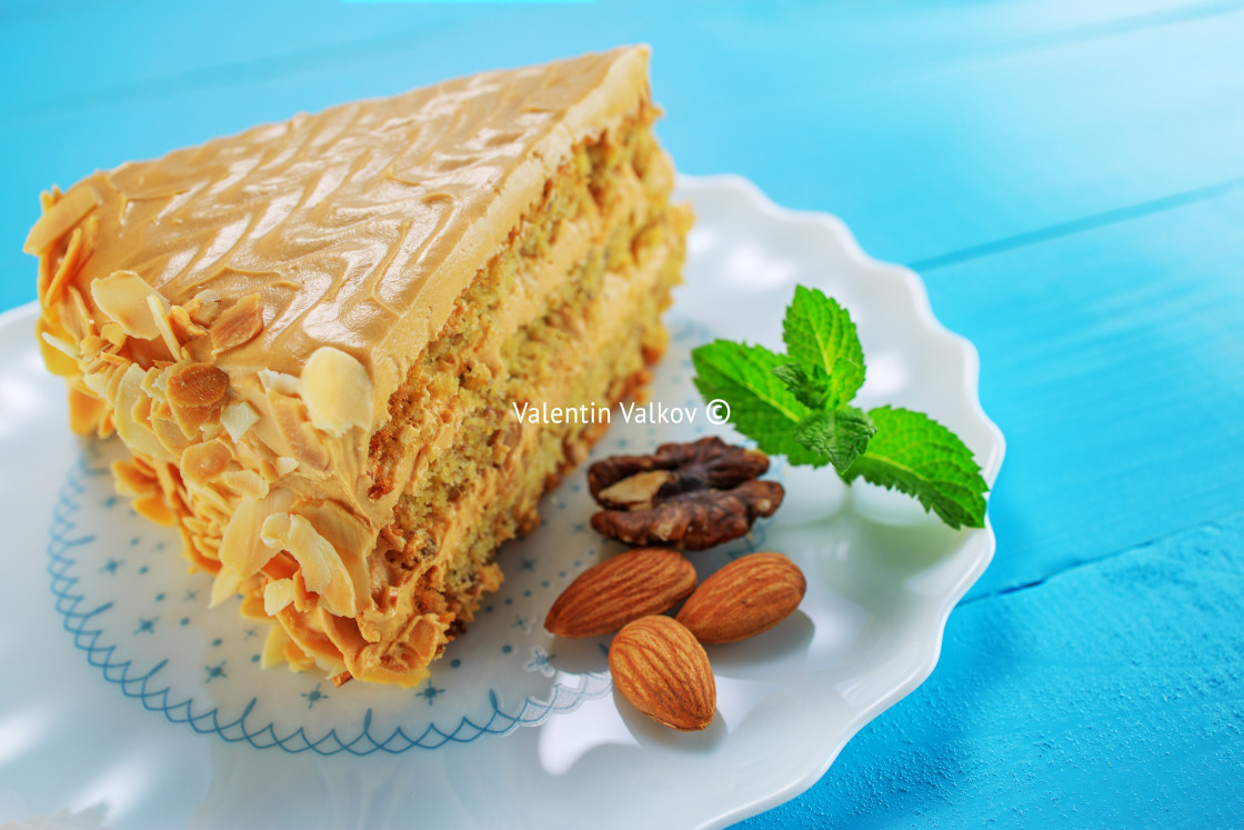 "Cake with peanuts, walnuts, chocolate and caramel cream on woode" stock image