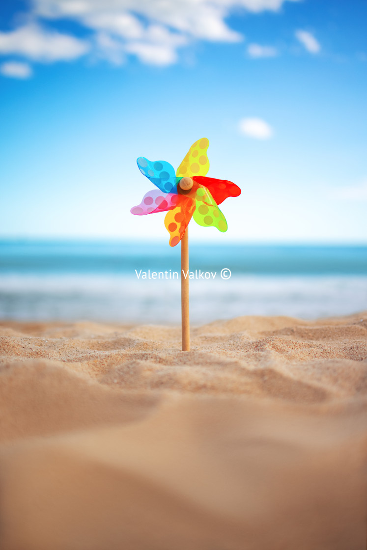 "Pinwheel on a beach sand against blue sky and sea, summer vacati" stock image