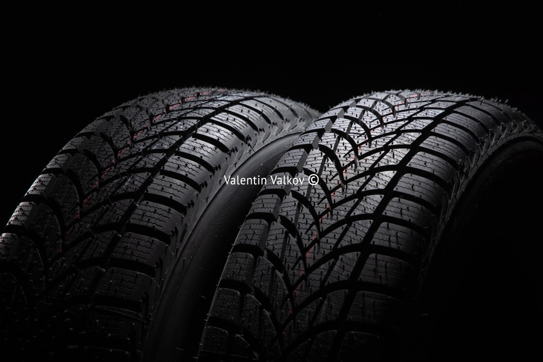 "Winter Car tire on black background" stock image