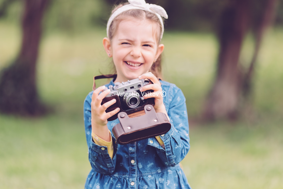 "Little girl with old vintage camera making photos of surrounding" stock image