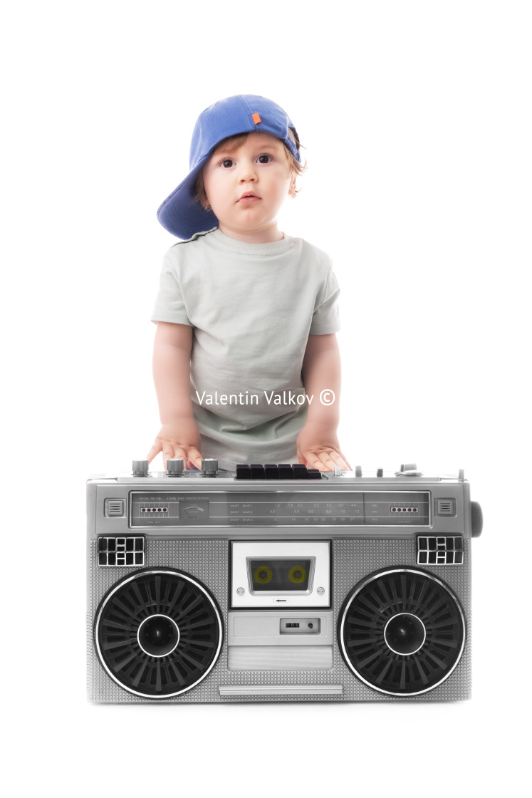 "Baby boy enjoying retro boombox radio and hip hop style" stock image