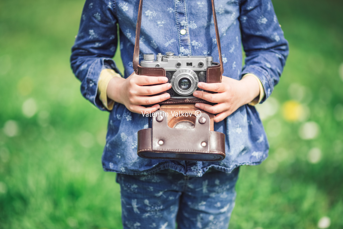 "Little girl with old vintage camera making photos of surrounding" stock image