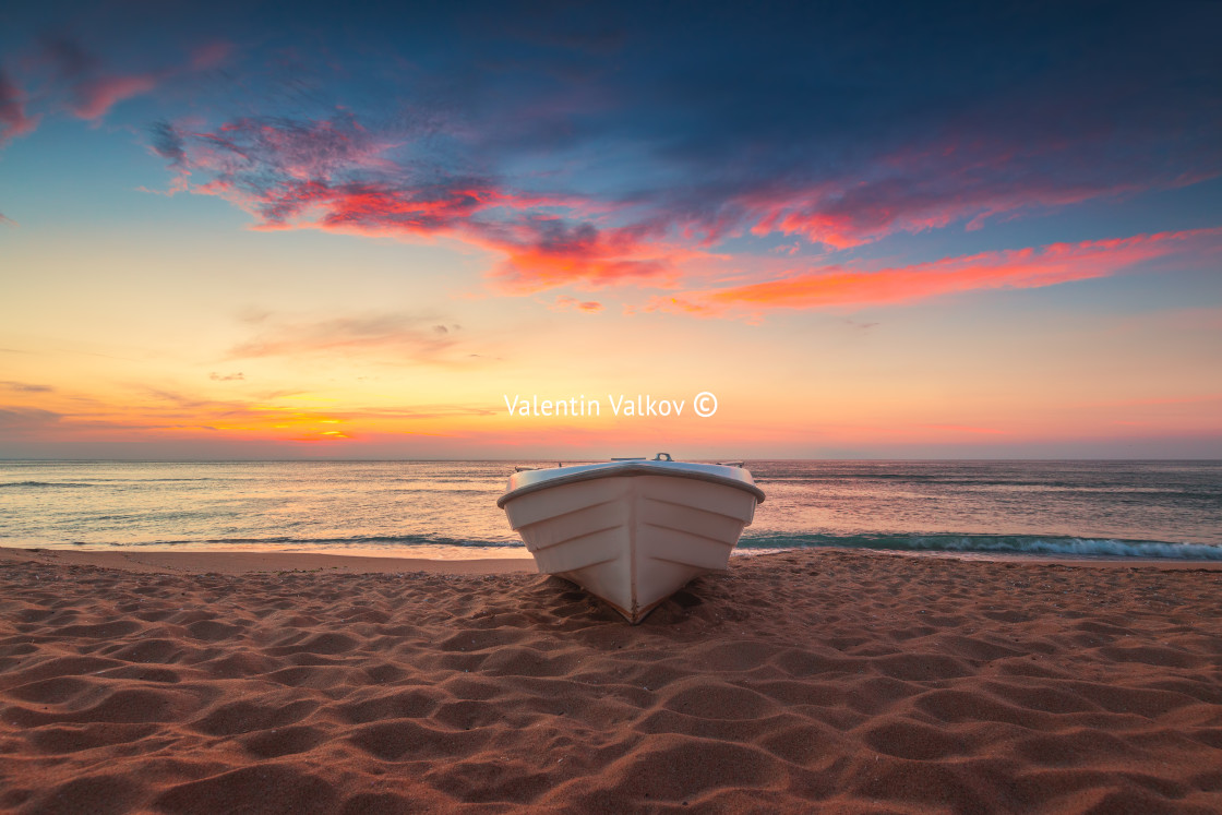 "Tropical Seascape with a boat on sandy beach at cloudy sunrise o" stock image