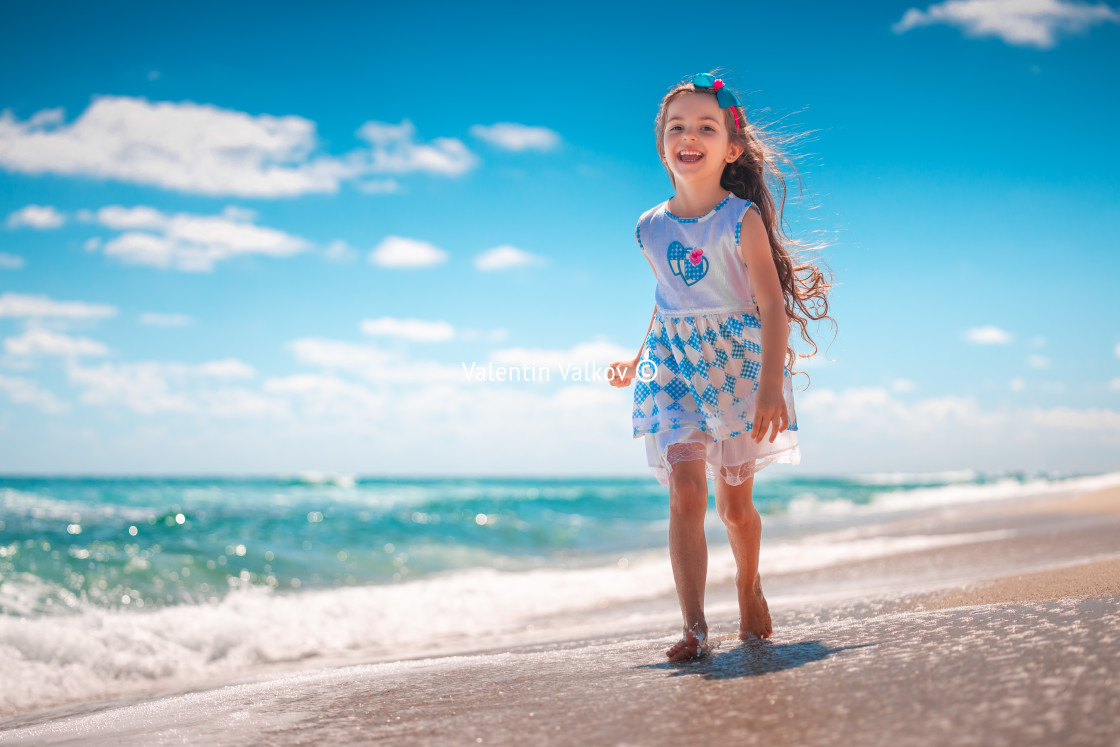 "Happy girl running on tropical beach on summer holidays" stock image