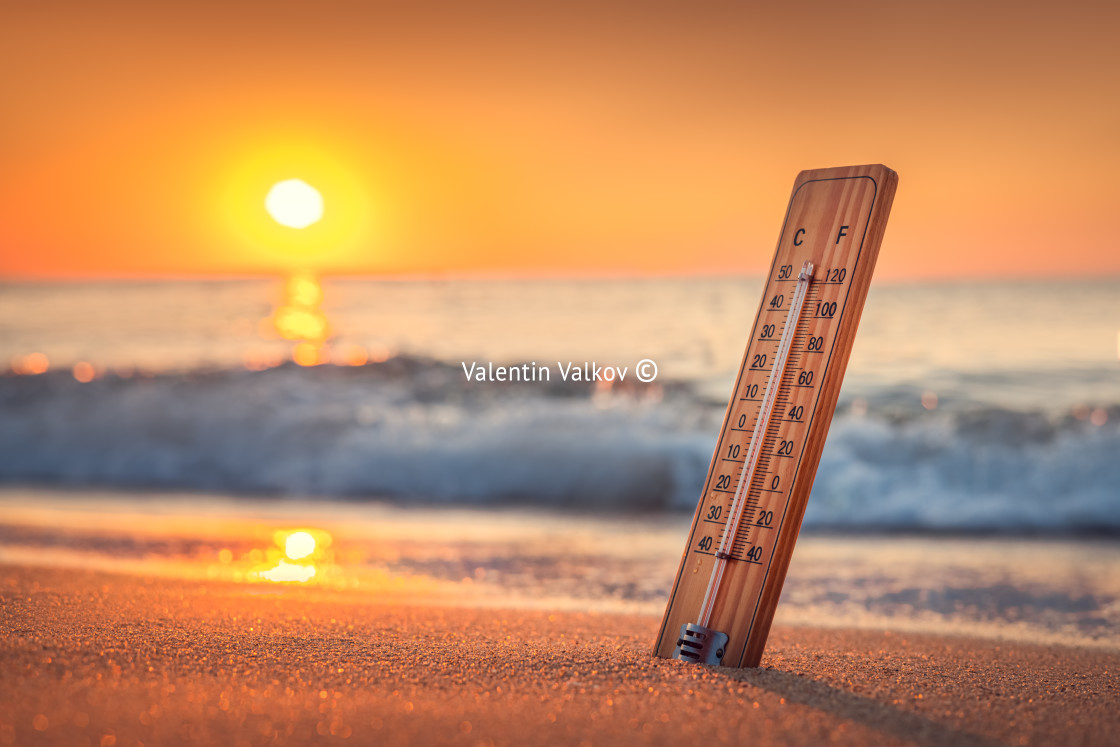 "Thermometer and sunrise over the beach. The heat. Hot summer day" stock image