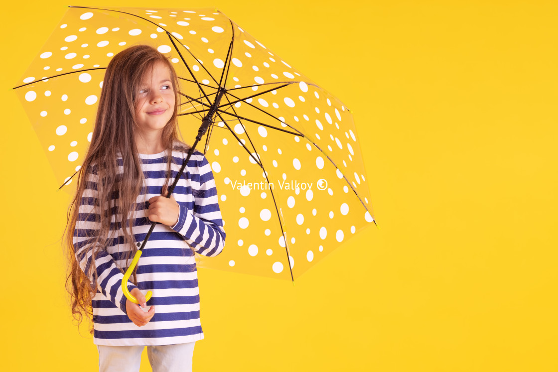 "Happy emotional girl laughing with umbrella on colored yellow ba" stock image