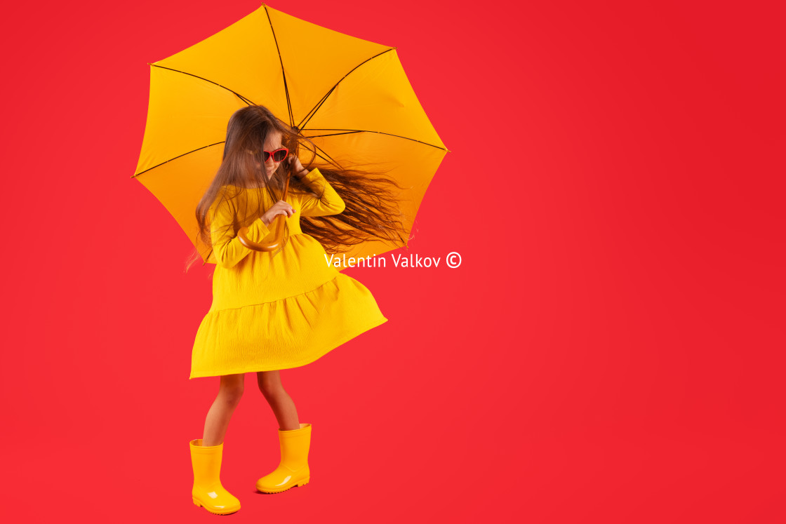 "Happy emotional girl laughing with umbrella on colored red backg" stock image