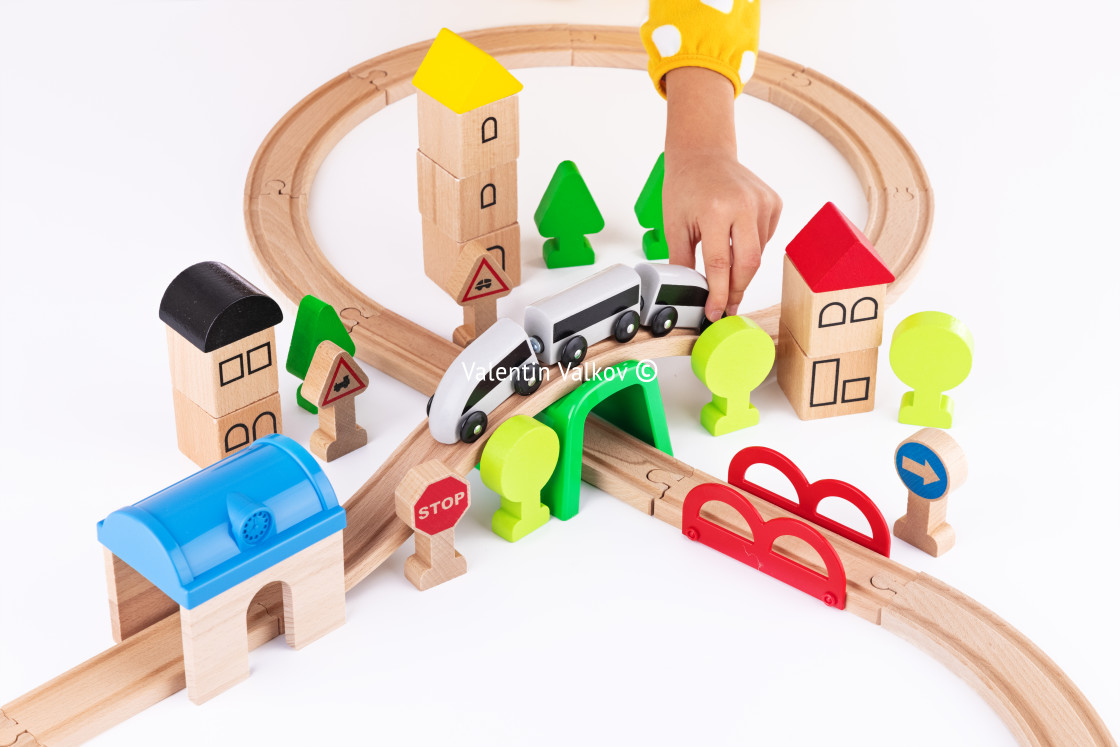 "Wooden train and railway road educational toys for kids on white" stock image