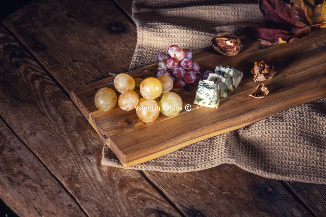 "Top view of grape and cheese on wooden table" stock image