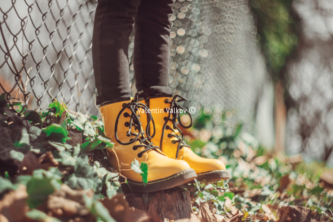 "Yellow boots of a jumping girl in green grass outdoor, defocus b" stock image