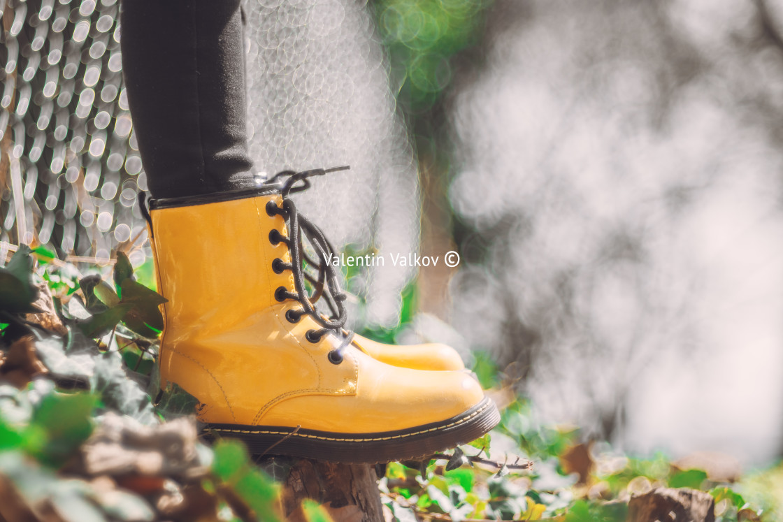 "Yellow boots of a jumping girl in green grass outdoor, defocus b" stock image