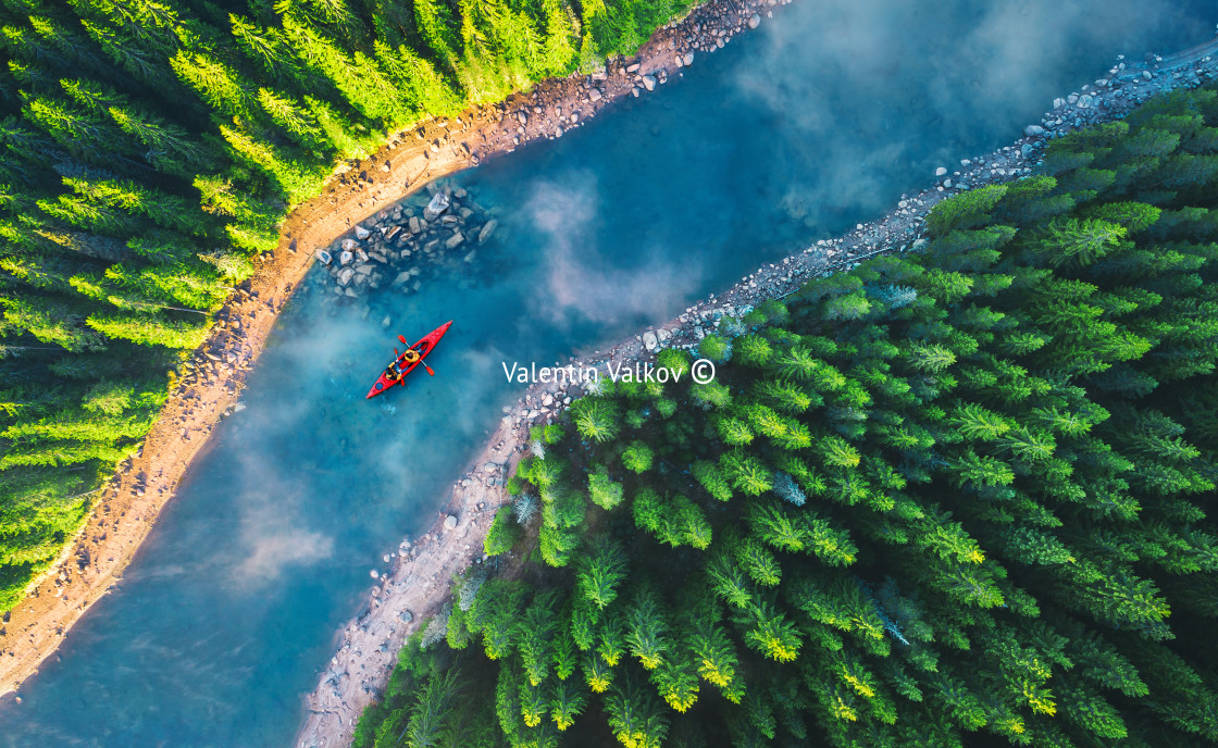 "Aerial view of rafting boat or canoe in mountain river and fores" stock image