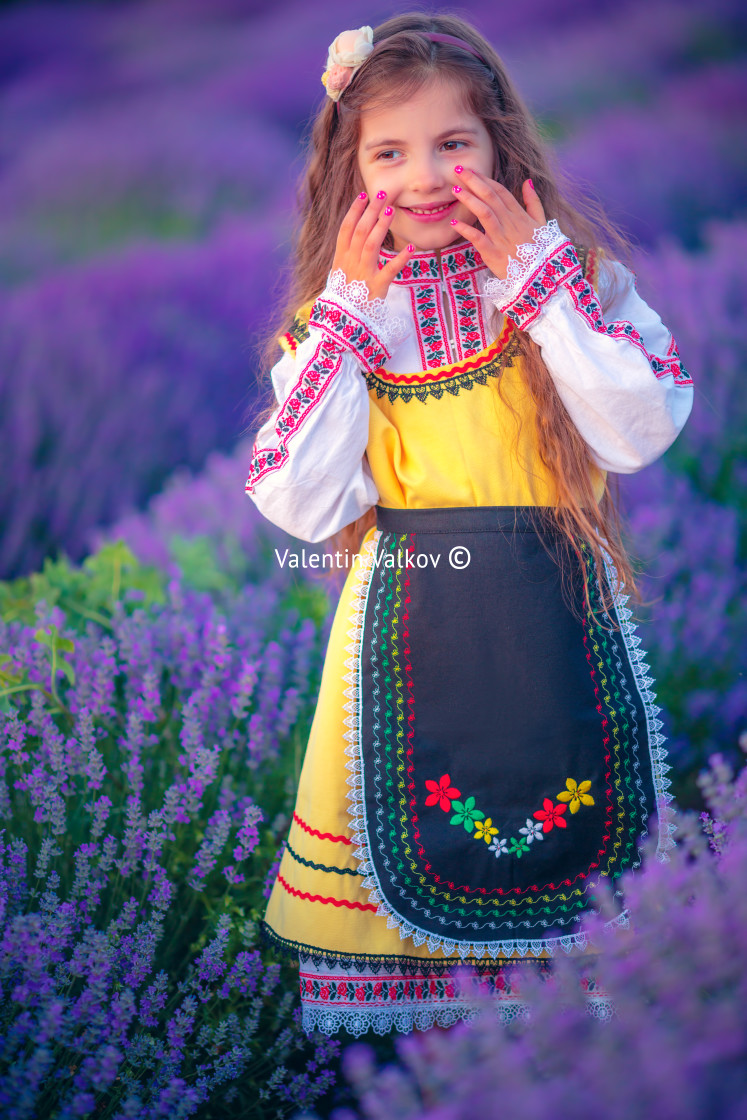 "Happy little girl with dress enjoying lavender field with bouque" stock image