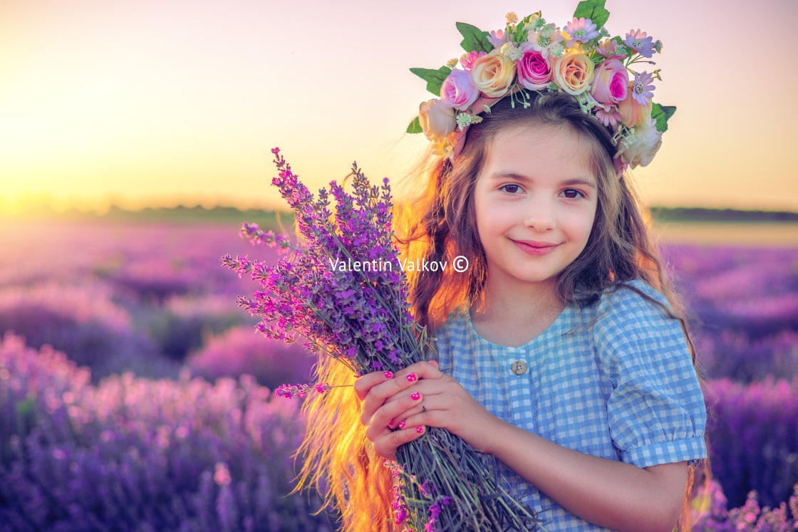 "Happy little girl with dress enjoying lavender field with bouque" stock image