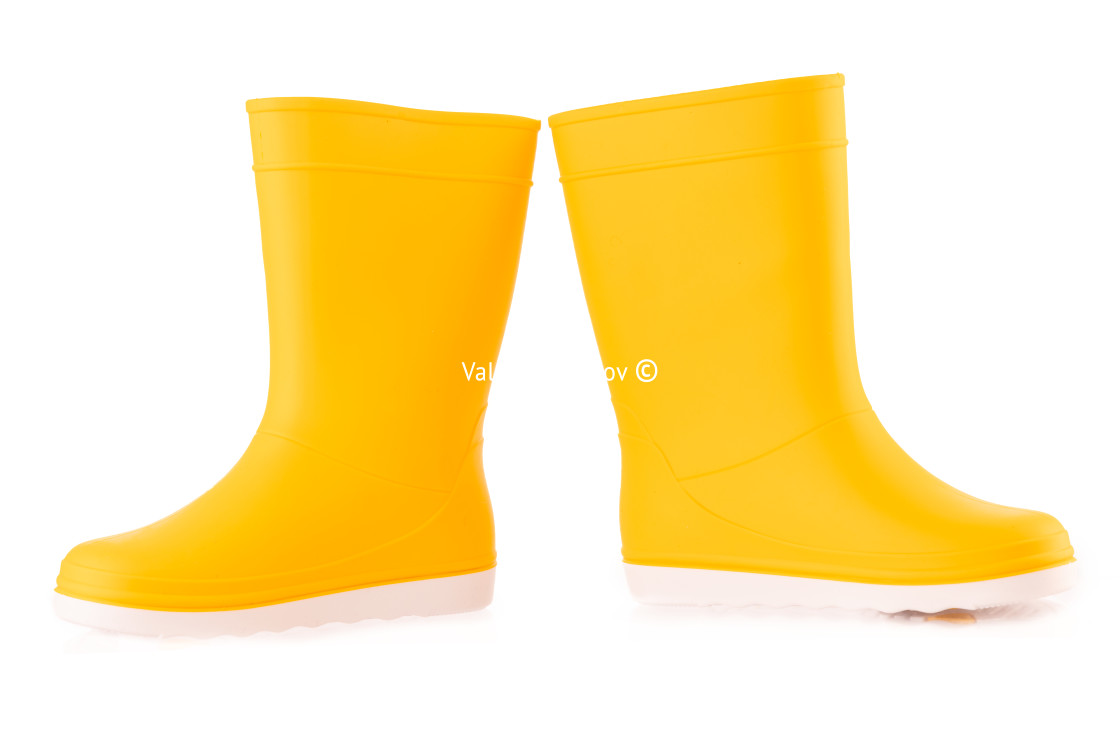 "Yellow rubber boots isolated on white background. Kids shoes." stock image