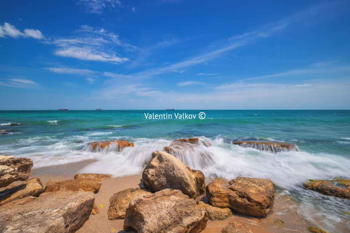 "Wild exotic beach with rocks in sea water. Rocky island coastlin" stock image