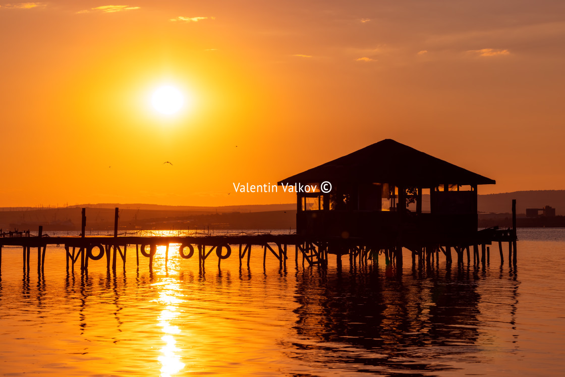 "Sunset over the sea lake and old wooden pier, romantic travel de" stock image