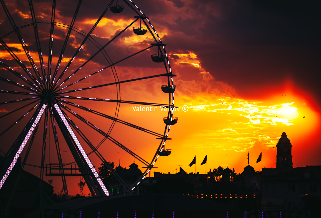 "Ferris Wheel and illuminations in amusement park during scenic s" stock image