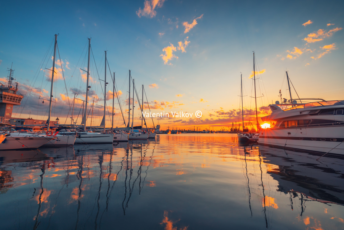 "Yacht port and beautiful sunset over Varna, Bulgaria. Sailboat harbor, many beautiful moored sail yachts in the sea." stock image